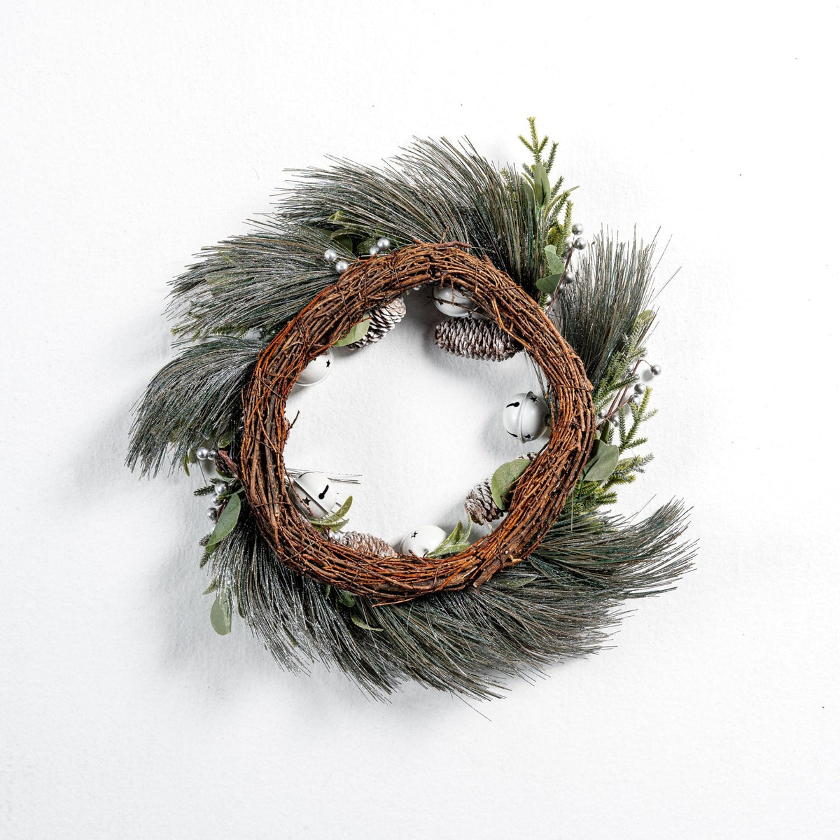 Pine wreath with white bell and pinecone